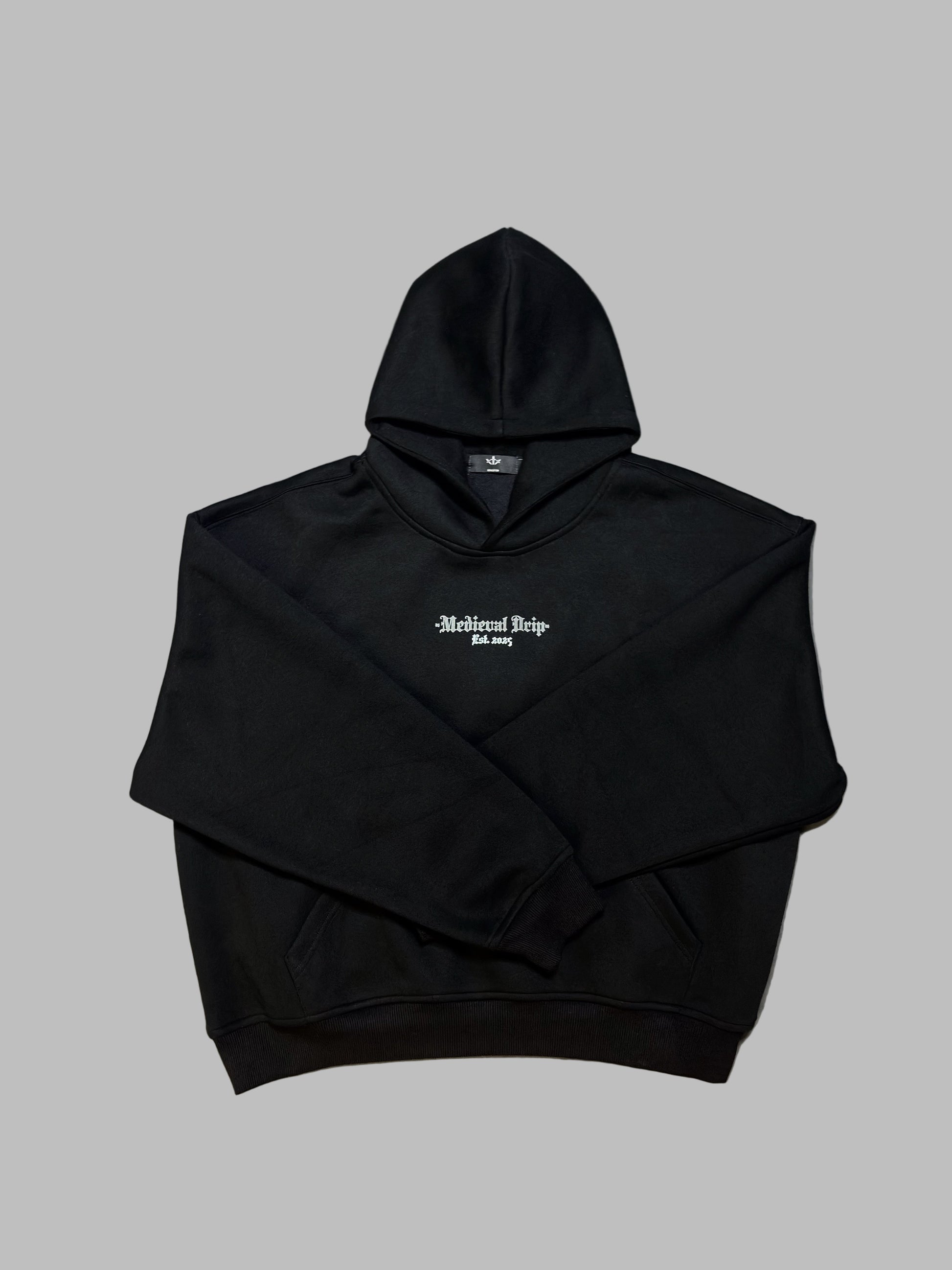 Black hoodie with white text on a gray surface
