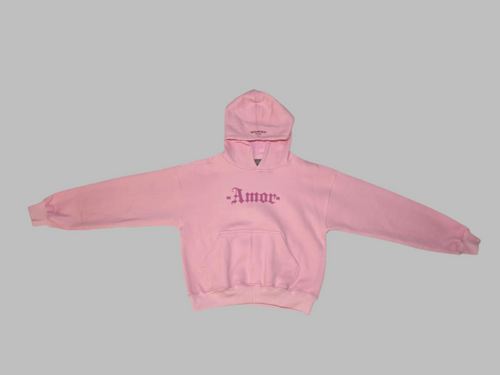 Pink hoodie with 'Amor' text on a white surface